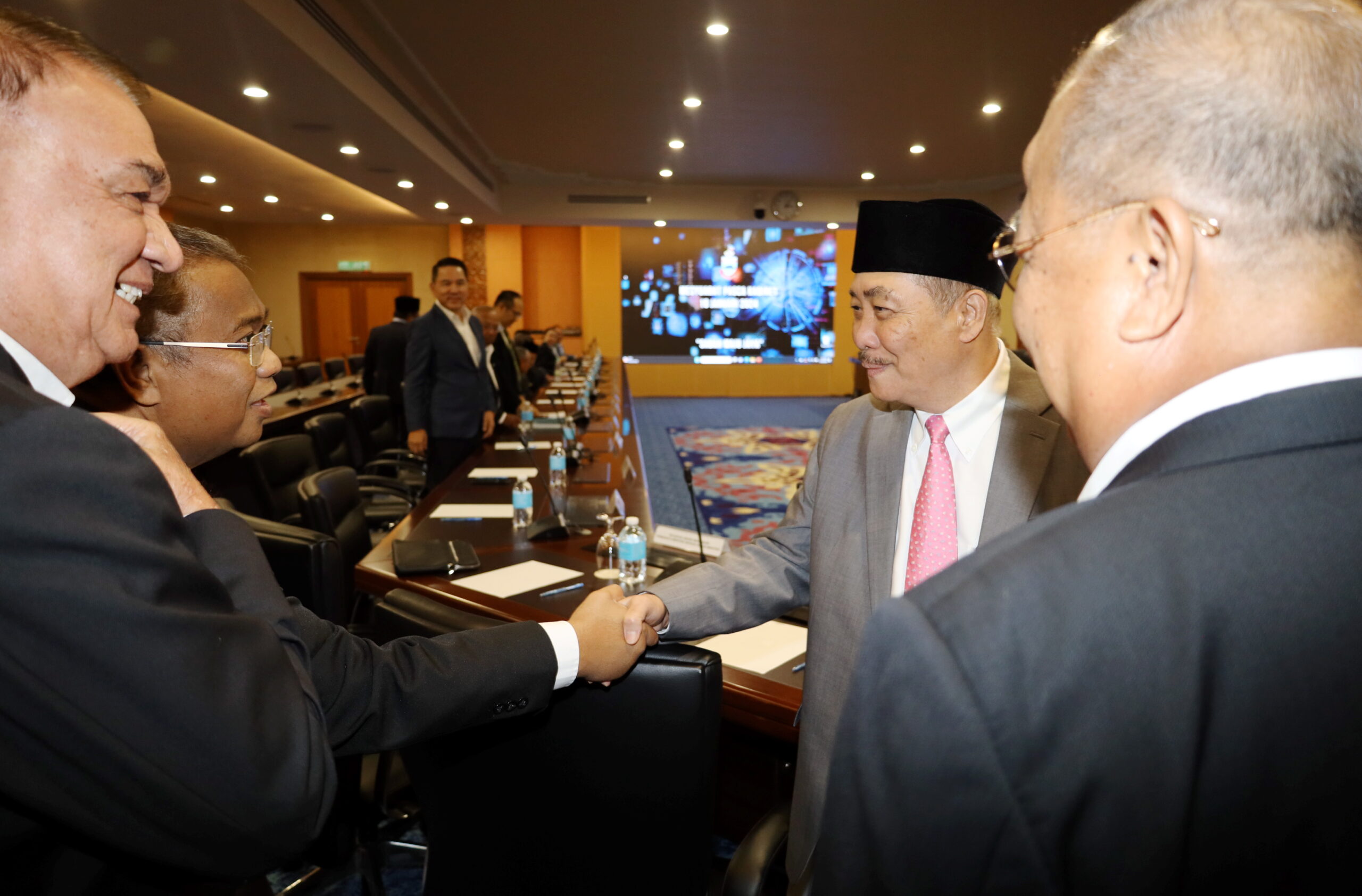 Chief Minister Datuk Seri Panglima Haji Hajiji Haji Noor shaking hands with some of the heads of department under the Chief Minister's Department.